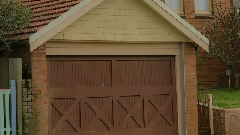 A brown carriage house style garage door with cross braces